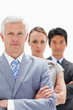 Close-up of a business man with subordinates behind him