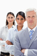 Close-up of a business man with two women behind him