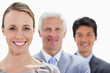 Close-up of smiling business people in a single line with focus on the woman