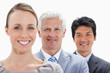 Photo: Close-up of smiling business people in a single line with focus on the middle person Close-up of smiling business people in a single line with focus on the middle person