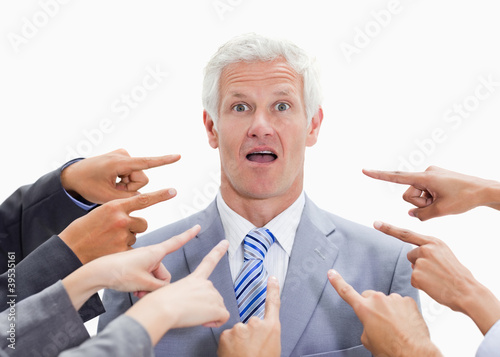 Photo: Shocked businessman with fingers being pointed at him Shocked businessman with fingers being pointed at him