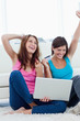 Successful young women holding a credit card and a laptop