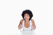 Young relaxed woman washing her face with water behind a bowl