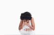 Young woman rinsing her face with water