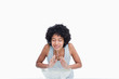 Calm young woman rinsing her face against a white background