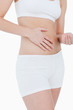 Woman in underwear touching her belly
