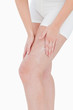 Woman applying cream on her thigh