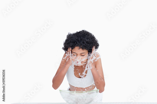 Photo: Young woman wearing a tracksuit while splashing with water Young woman wearing a tracksuit while splashing with water