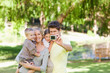 Smiling family in the park posing for a photo