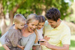 Smiling family looking at the photo they took