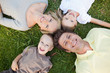A smiling family lying on the ground together