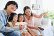Happy family sitting and watching tv