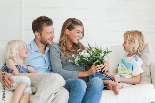 Photo: A mother smiles with joy as she is given a bouquet of flowers A mother smiles with joy as she is given a bouquet of flowers
