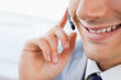 Close-up of a smiling man's mouth talking with a headset