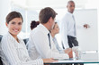 Smiling saleswoman with presentation being held behind her
