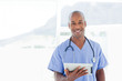 Smiling doctor with tablet computer