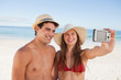 Smiling couple in swimsuit taking a picture together