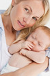 Close up of woman holding her sleeping baby