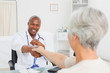 Smiling doctor shaking his patients hand