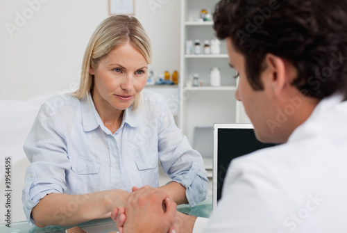 Photo: Woman listening closely to doctor Woman listening closely to doctor
