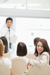 Happy brown haired woman looking behind her during a speech