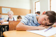Tired student taking a rest at his desk