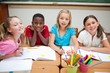Smiling students painting during art class