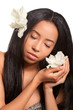 Beautiful young woman with golden tan and flowers in her hair an Beautiful young woman with golden tan and flowers in her hair an