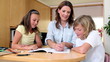 Mother helping her children with homework