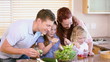 Family making a salad with vegetables