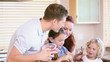 Family standing while preparing a meal
