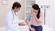 A doctor taking the patients blood pressure
