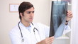 A doctor examining an x-ray scan