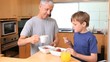 Video: Father and son eating their breakfast together Father and son eating their breakfast together