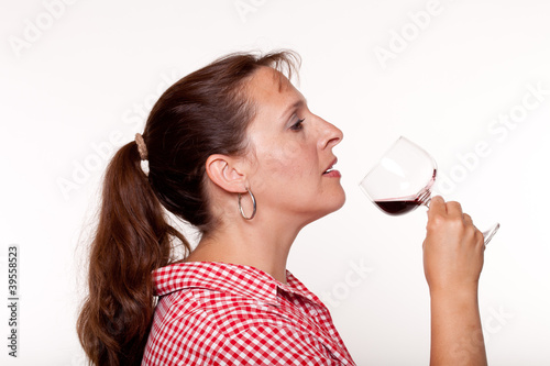 Photo: Woman in a red checked shirt drinking red wine Woman in a red checked shirt drinking red wine