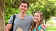 Video: Camera rises to show a woman smiling while a man holds his arm around her shoulders Camera rises to show a woman smiling while a man holds his arm around her shoulders
