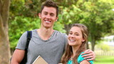 Video: Camera rises to show a woman smiling while a man holds his arm around her shoulders Camera rises to show a woman smiling while a man holds his arm around her shoulders