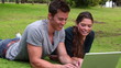 Video: Two friends talking to each other as they use a laptop while lying together Two friends talking to each other as they use a laptop while lying together