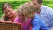 Video: Family open a picnic basket to take out slices of watermelon before beginning to eat Family open a picnic basket to take out slices of watermelon before beginning to eat