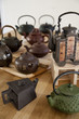 A collection of antique ceramic Asian teapots