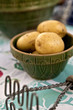 A vintage bowl full of potatoes and antique masher