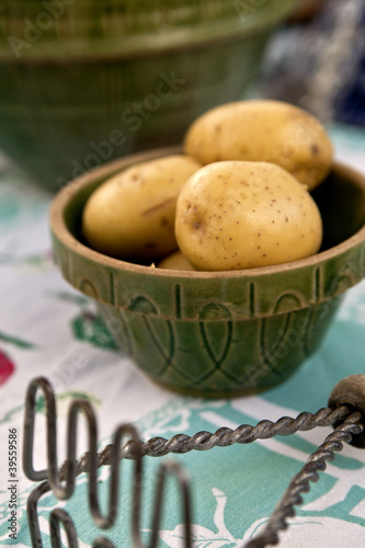 Photo: A vintage bowl full of potatoes and antique masher A vintage bowl full of potatoes and antique masher