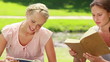 Video: The camera pans across two women reading books The camera pans across two women reading books