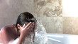 Brunette woman in slow motion taking a bubble bath