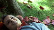 Video: Brunette lying on grass in slow motion Brunette lying on grass in slow motion