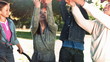 Family throwing leaves in slow motion