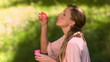 Woman blowing bubbles in slow motion