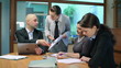 Female boss giving reprimand to her workers at business meeting