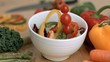 Vegetables falling into bowl in super slow motion