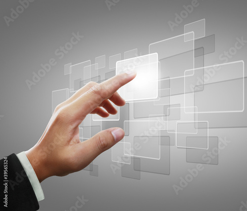 Foto: hand pushing on a touch screen interface hand pushing on a touch screen interface